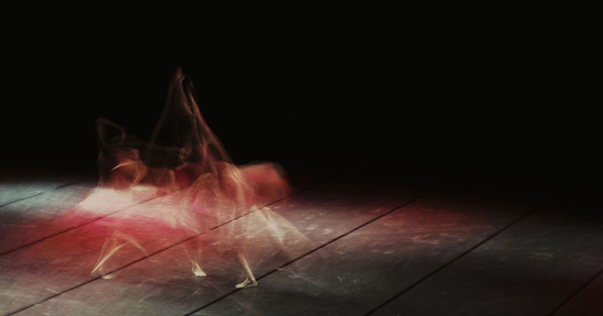 Artistic long exposure of a ballet dancer in motion, showcasing dynamic movement on stage.