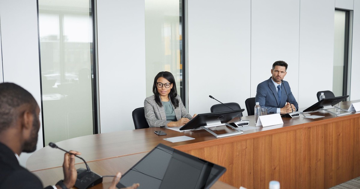 Professionals engaging in a meeting in a bright, modern conference room showcasing diversity and collaboration.