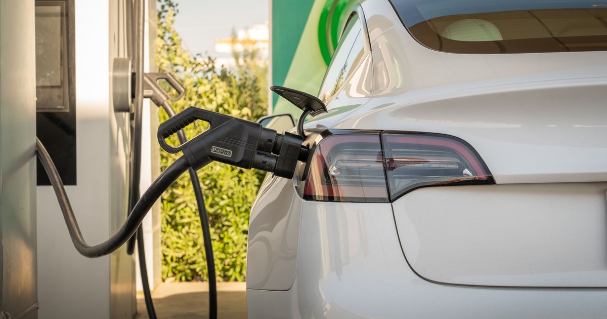 Electric Tesla car charging at a station in Erbil, Iraq. Eco-friendly transportation.