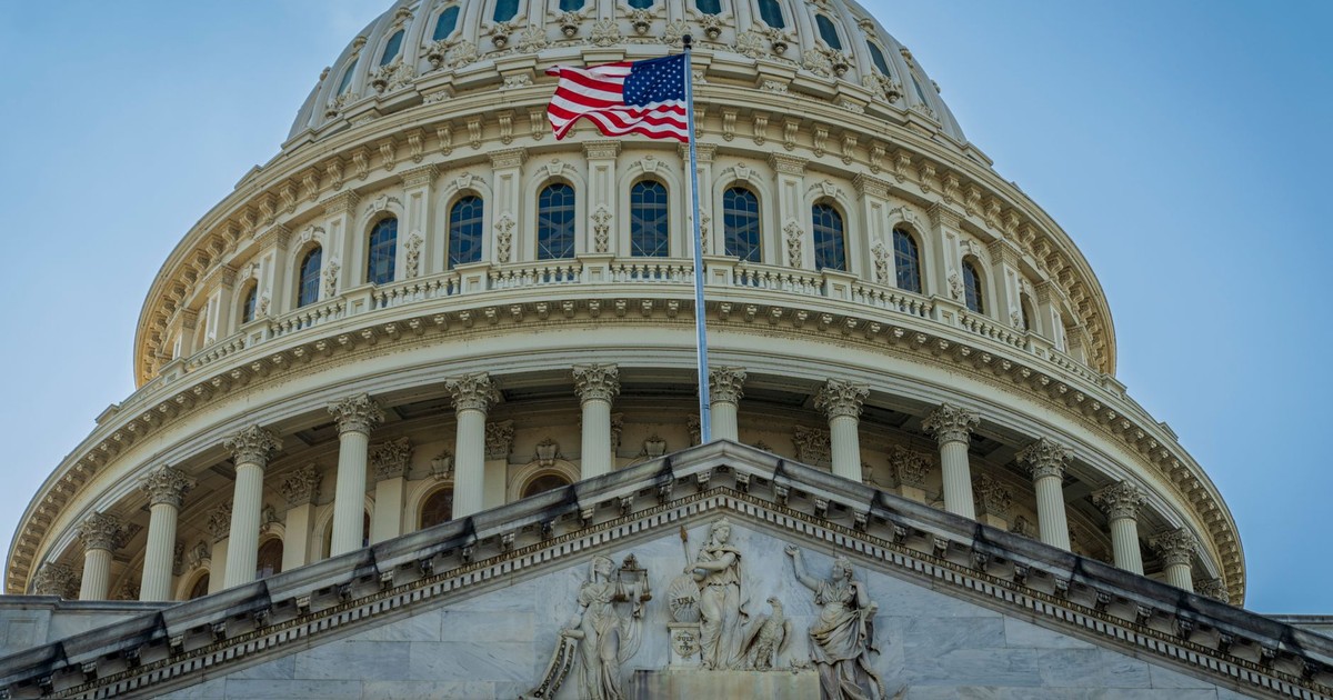 Close-up view of the iconic United States Capitol dome with American flag in Washington, D.C.