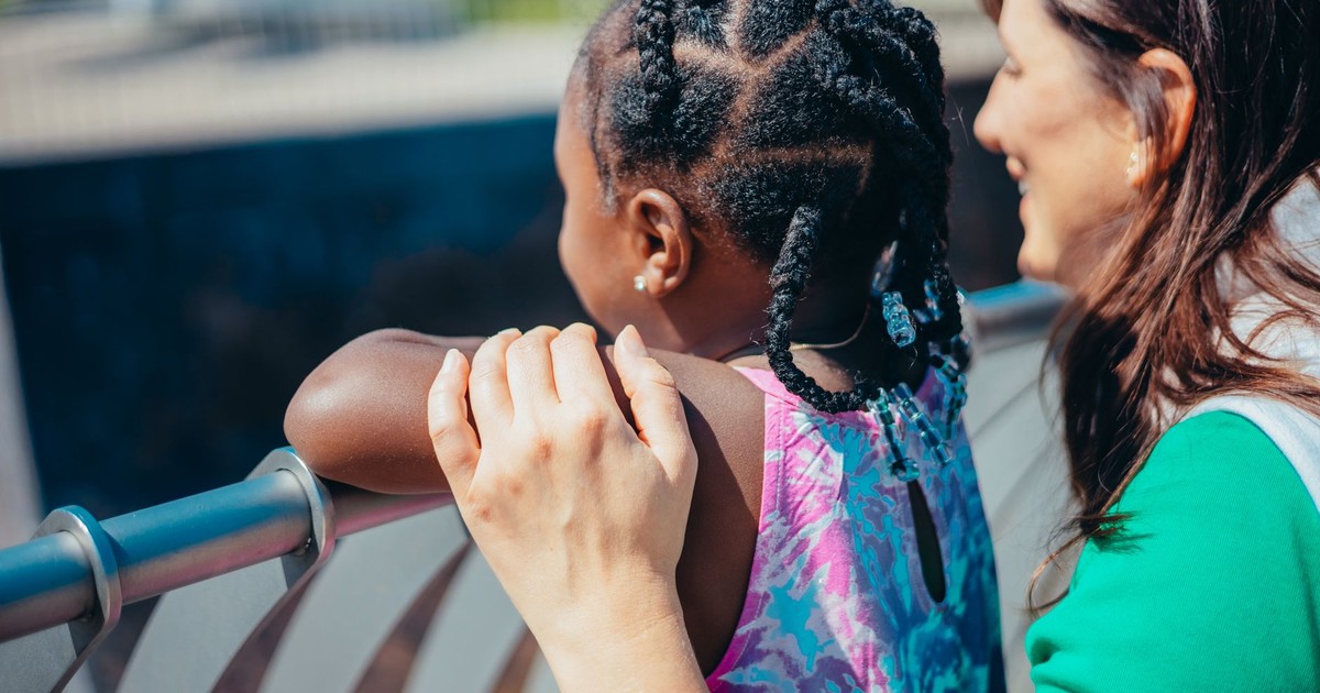 A heartwarming moment between a mother and daughter enjoying time outdoors.