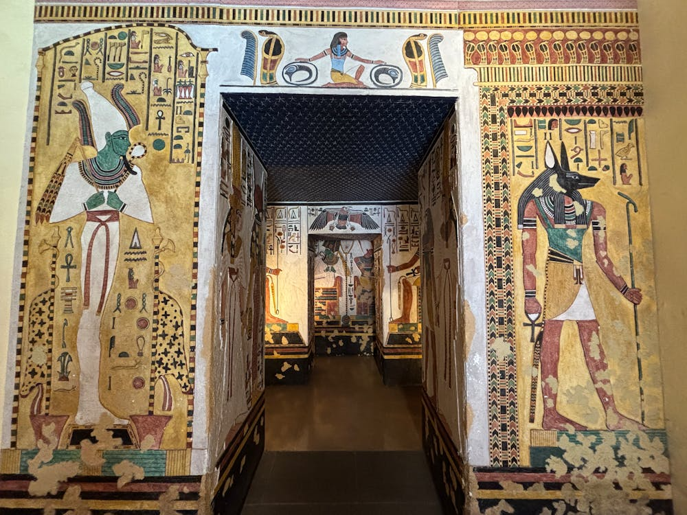 Intricately decorated ancient Egyptian tomb with colorful hieroglyphs and deities.