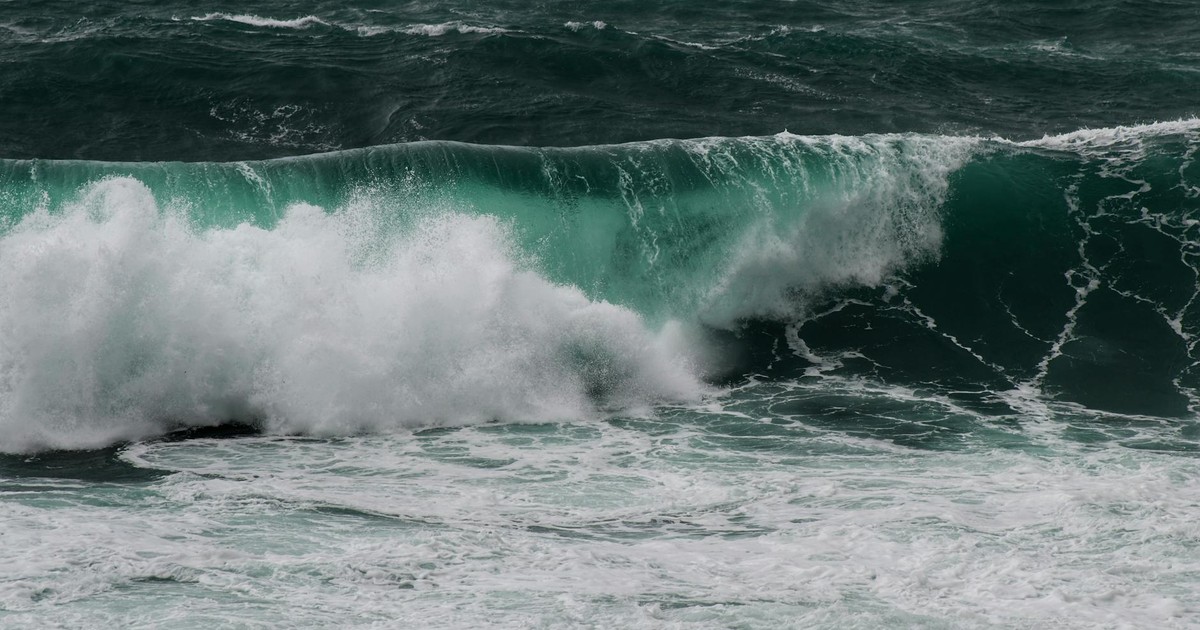 Dynamic ocean wave crashing with force, showcasing the powerful and tumultuous nature of the sea.