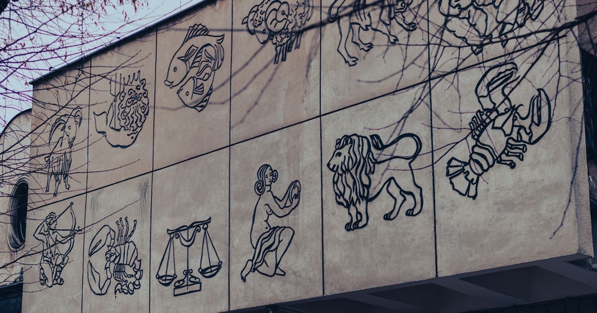 Outdoor mural depicting zodiac signs on a building wall in Chrzanow, Poland.