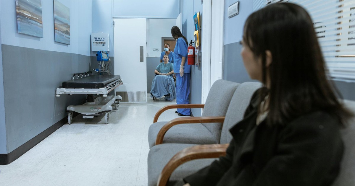 A hospital scene showing patients and medical staff in a corridor, illustrating healthcare environments.