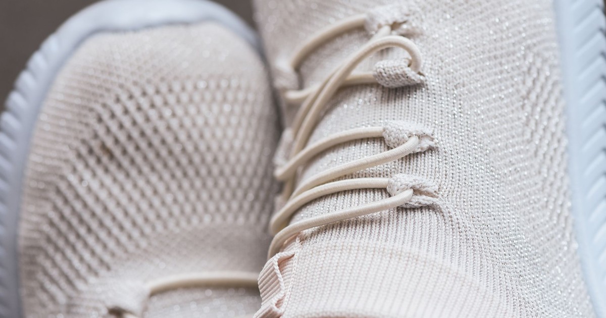 Close-up of trendy beige sneakers showcasing texture and style. Perfect for fashion enthusiasts.