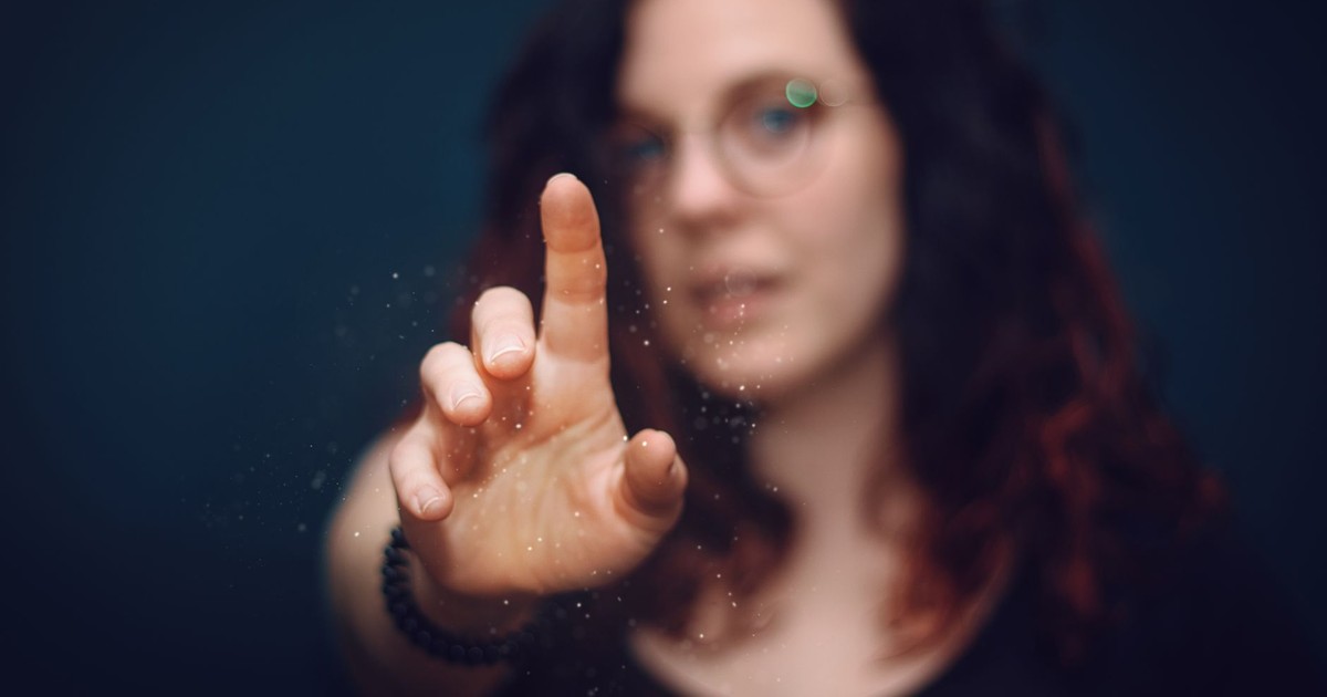 A woman reaching out with her finger, creating a sense of interaction and curiosity.