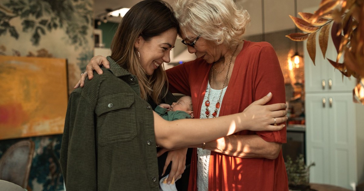 A heartwarming moment as a grandmother hugs her family, expressing love and connection.