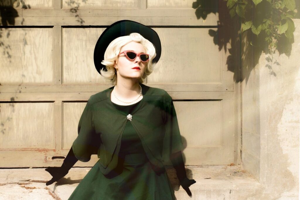 Elegant woman in vintage attire poses against a rustic wooden background, exuding classic retro style