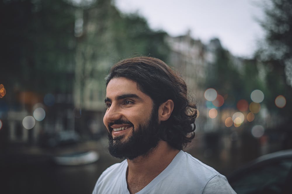 Portrait of a happy bearded man smiling on a street in Greece
