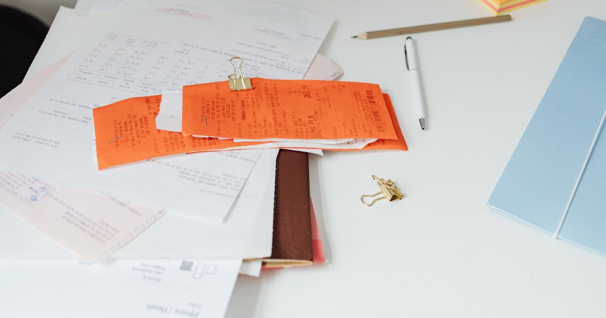 Close-up of a tidy desk with receipts, documents, and office stationery for business organization.