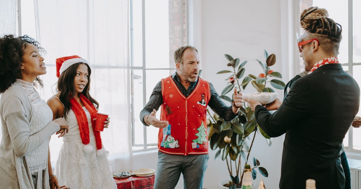 A lively office holiday party with coworkers enjoying festivities indoors.