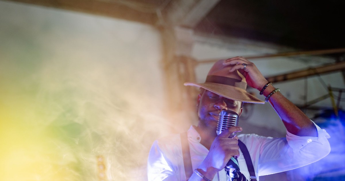 A captivating jazz singer performs with a vintage microphone, creating a moody musical ambience.