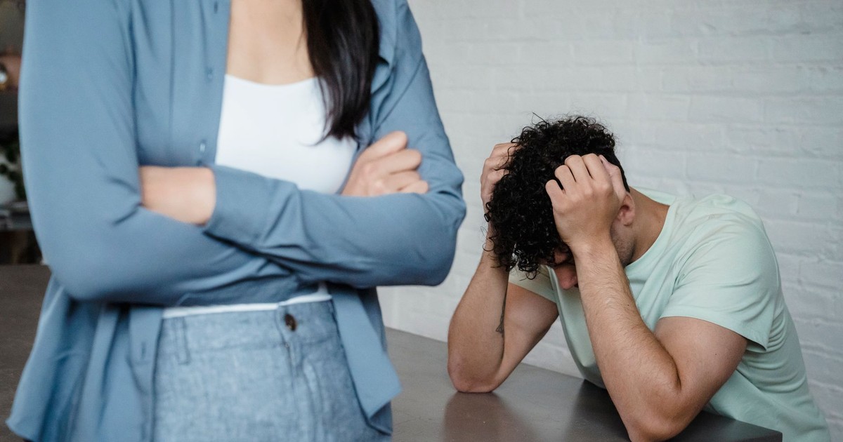 A couple experiencing relationship stress and conflict in an indoor setting, illustrating discord and tension.