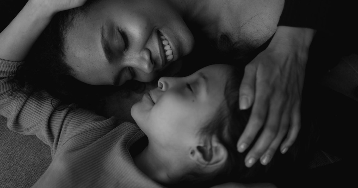 Heartwarming black and white portrait capturing a joyful mother and daughter embracing.