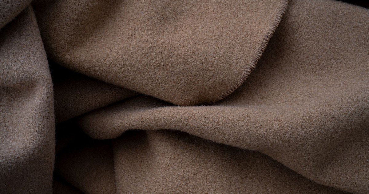 Close-up of a soft brown fabric, ideal for cozy and warm-themed projects.