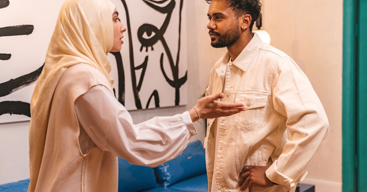 A man and woman in an intense conversation at home, evoking emotions.