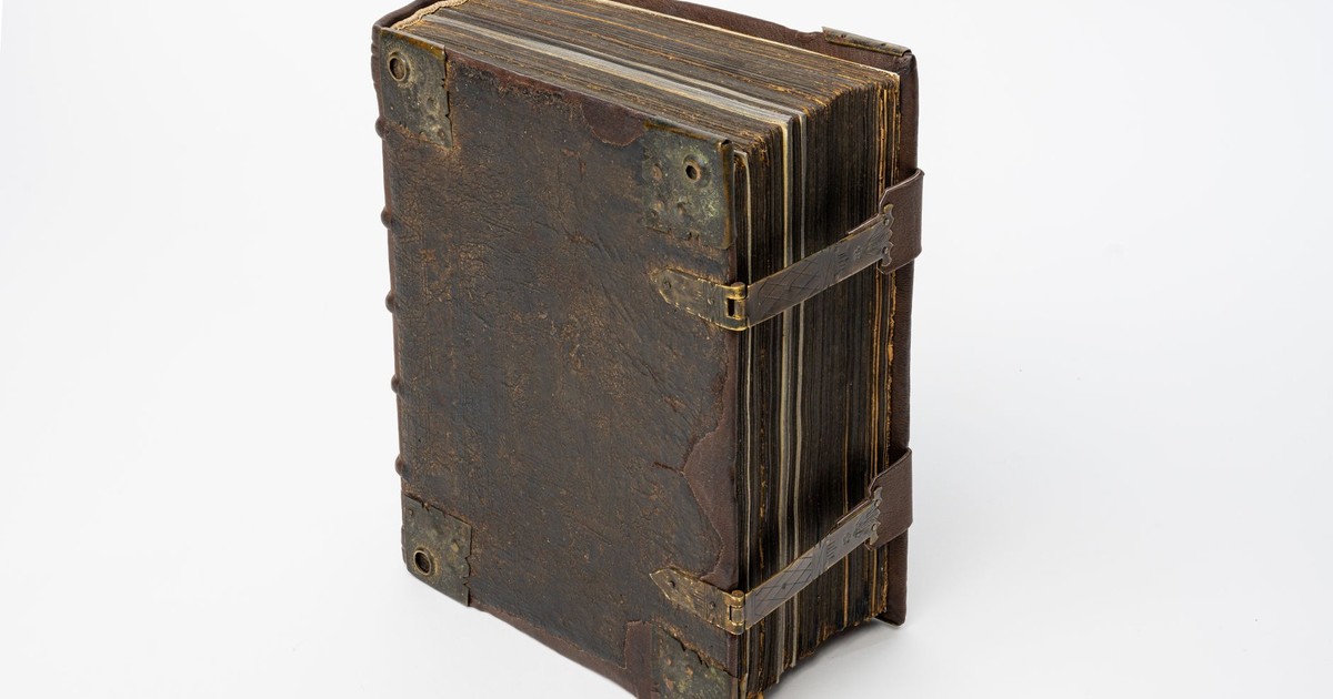 A detailed studio shot of an antique leather-bound manuscript, showcasing its aged and classic appearance.