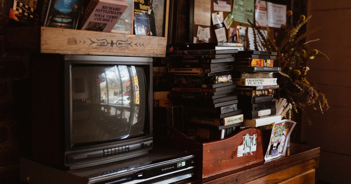 Classic setup of a retro-oriented living area featuring an old TV, VHS tapes, and vintage decor.