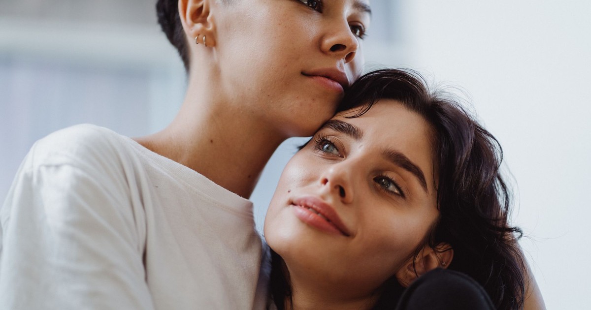 Intimate portrait of a couple embracing with affection indoors.