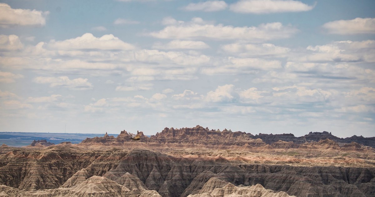 Dramatic landscape of Badlands National Park under a cloudy sky.