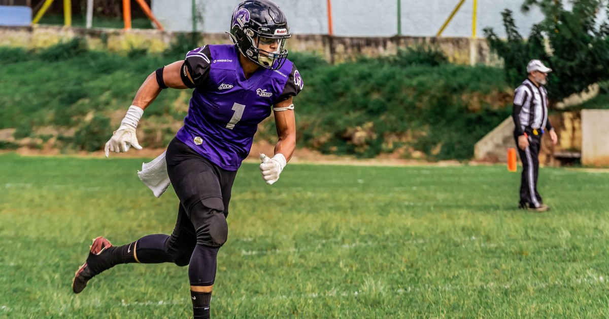 Dynamic shot of an American football player in action on the field.