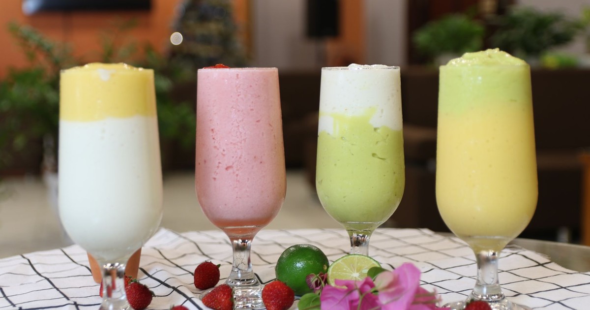 A vibrant array of healthy fruit smoothies in wine glasses, perfect for a balanced diet.