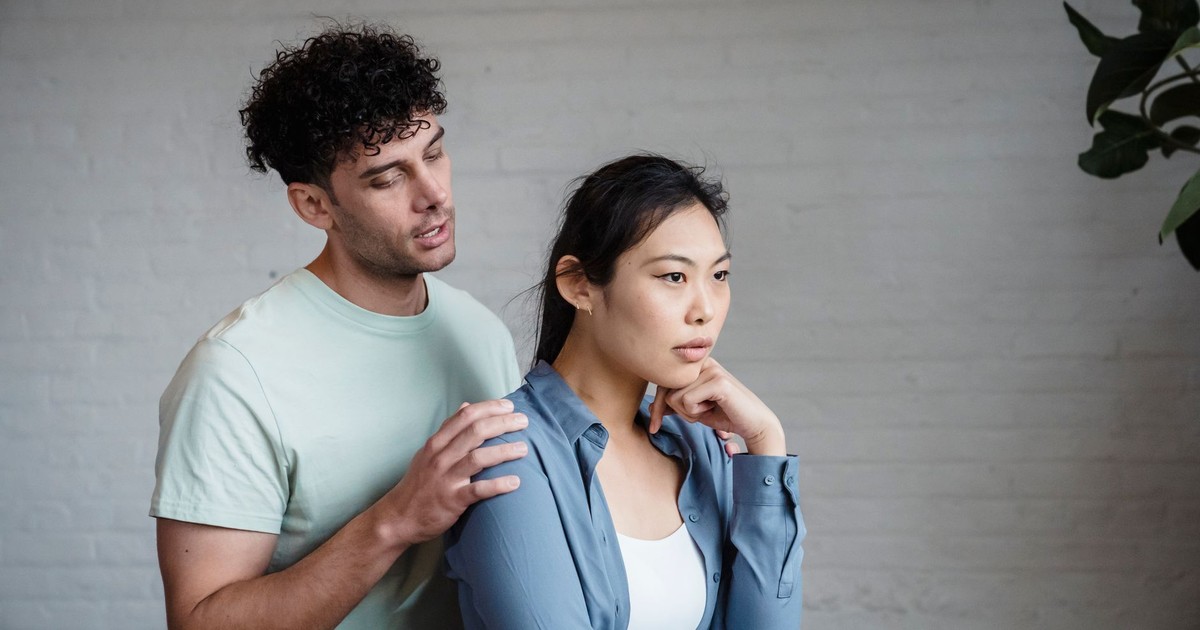A couple engaged in emotional discussion indoors, reflecting relationship dynamics.