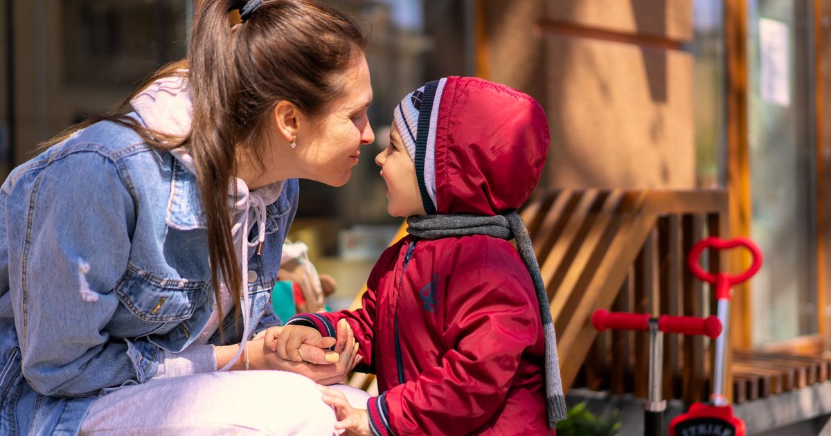 A loving mother and her son enjoy a playful moment outdoors, capturing warmth and joy.