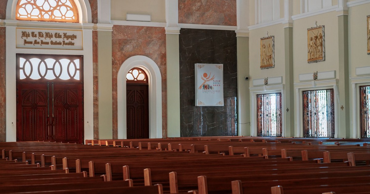 A serene empty church interior showcasing arches and elegant wooden pews, ideal for religious spirituality themes.