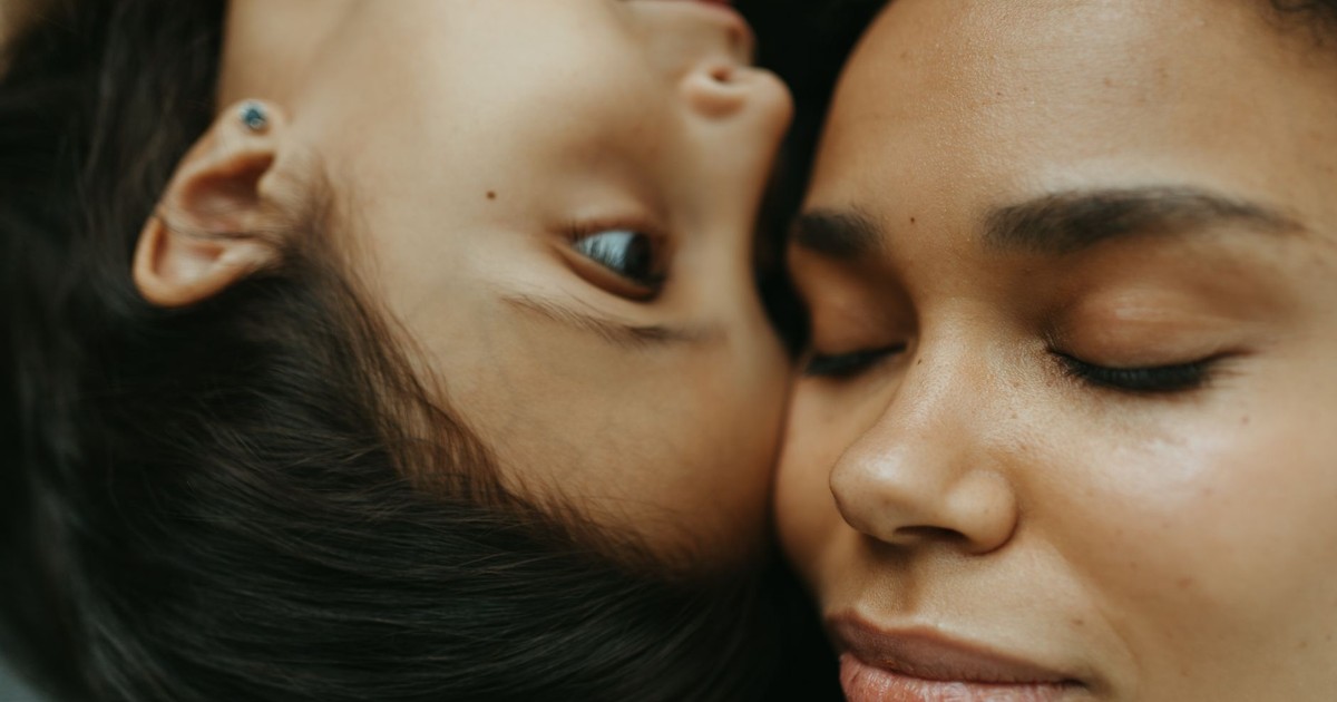 A heartfelt close-up capturing a mother and child embracing in a serene, loving moment.