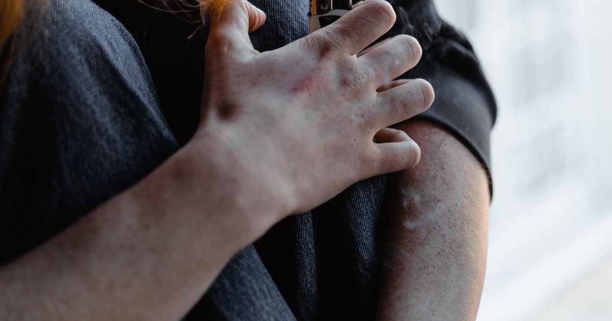 Dramatic close-up of a hand holding a lighter, conveying tension or anxiety.