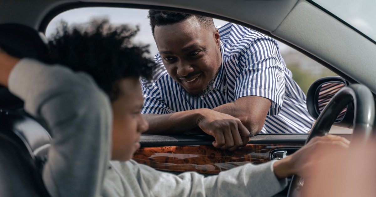 Father teaching his son how to drive, bonding and learning together.