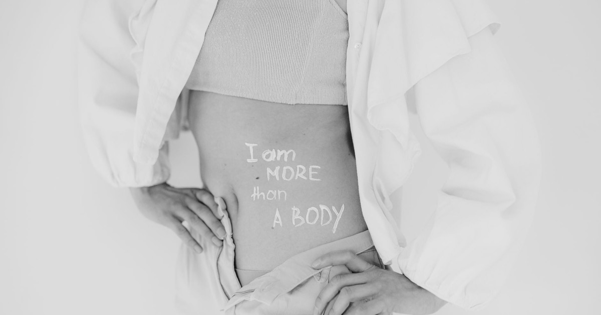 Black and white image promoting body positivity with 'I am more than a body' message.