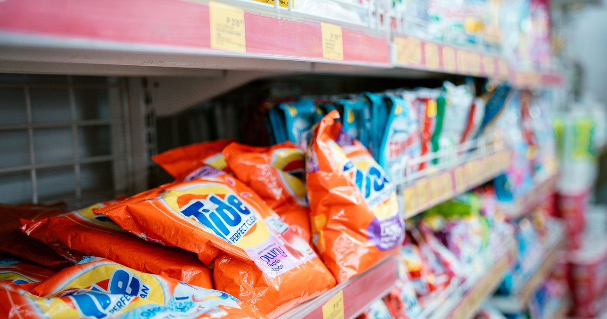 Vibrant selection of laundry detergents on a supermarket shelf, showcasing brands and variety.