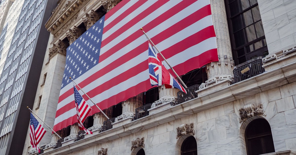 American flag on a historic building exterior symbolizing patriotism and national pride.