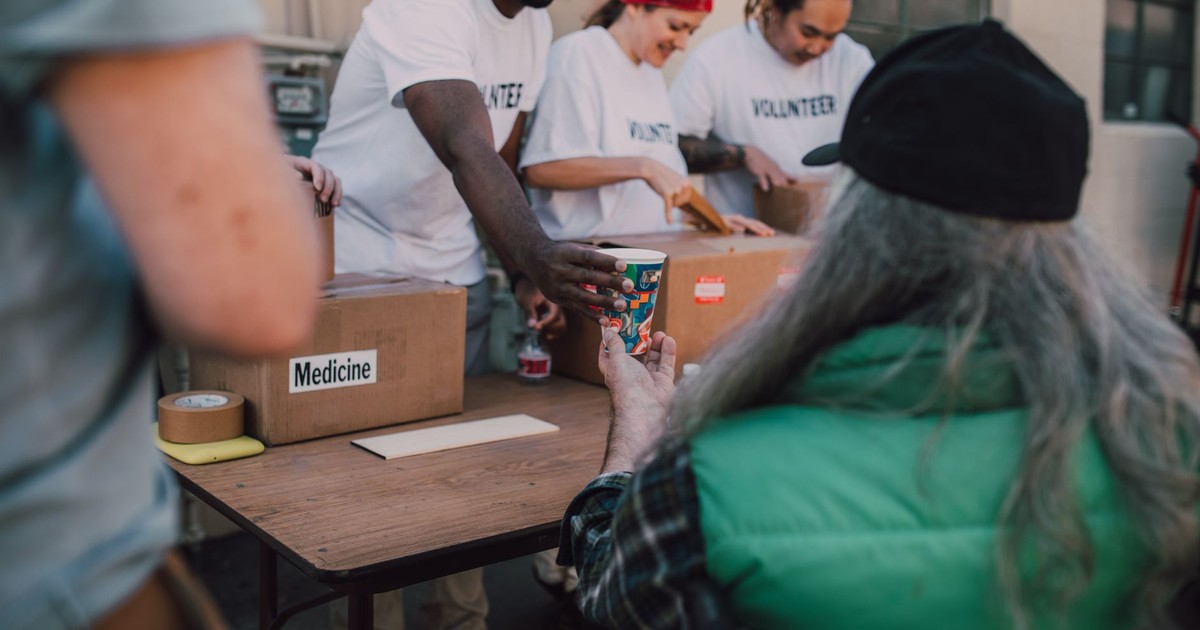 Volunteers handing out donations and support to those in need at a community event.