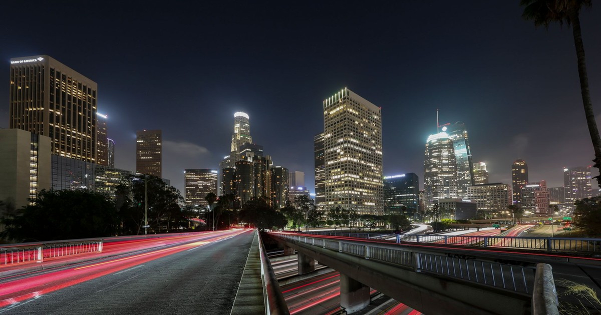 Vibrant long exposure of Downtown Los Angeles skyscrapers at night, showcasing the city skyline.