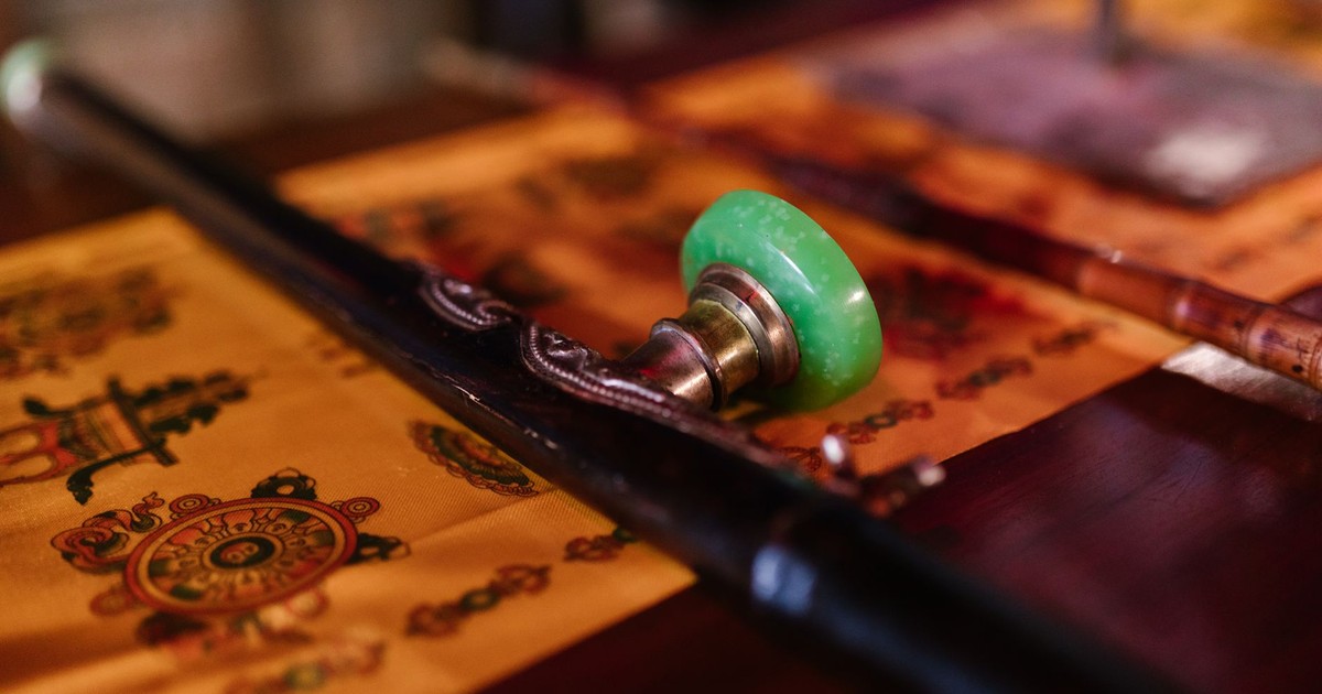Close-up of traditional Buddhist ritual objects placed on a decorative fabric. Perfect for spirituality and cultural concepts.