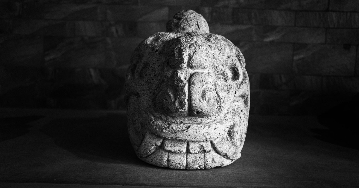 Black and white image of an ancient stone sculpture on display in Huaraz, Peru.