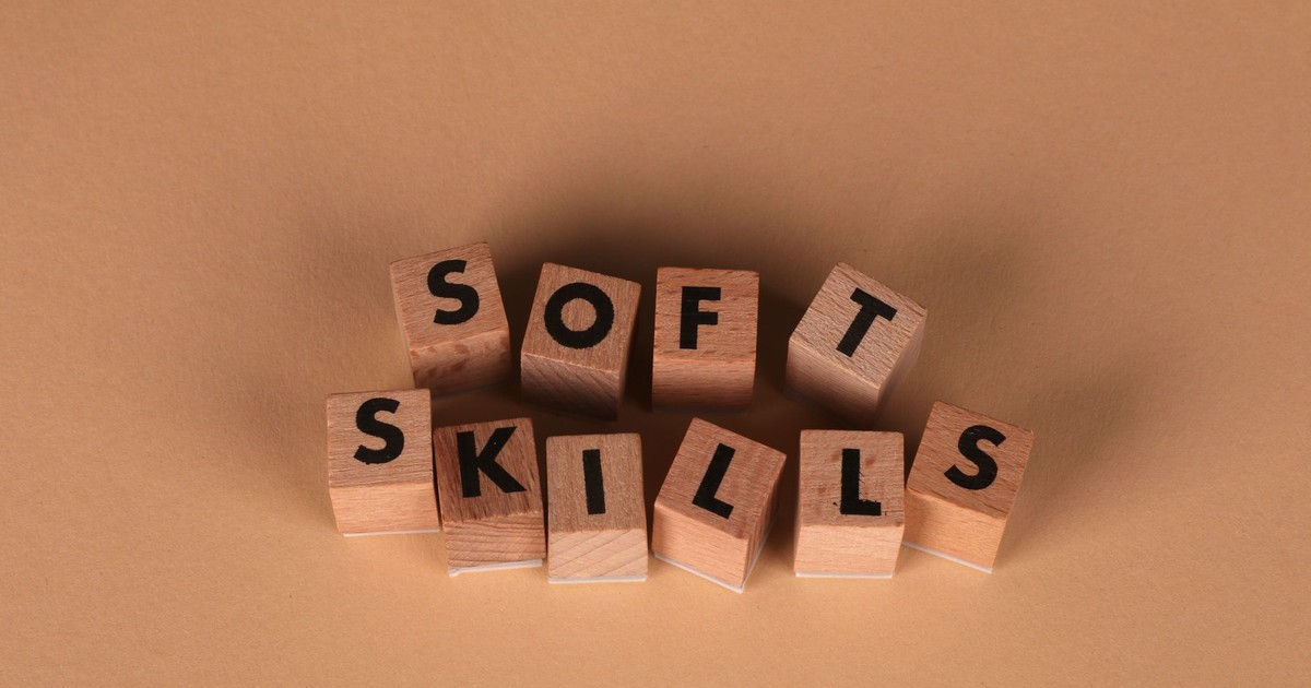Wooden letter blocks spell out 'Soft Skills', highlighting business and personal development concepts.