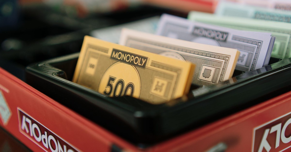 Detailed view of Monopoly game money and box, ideal for board game enthusiasts.