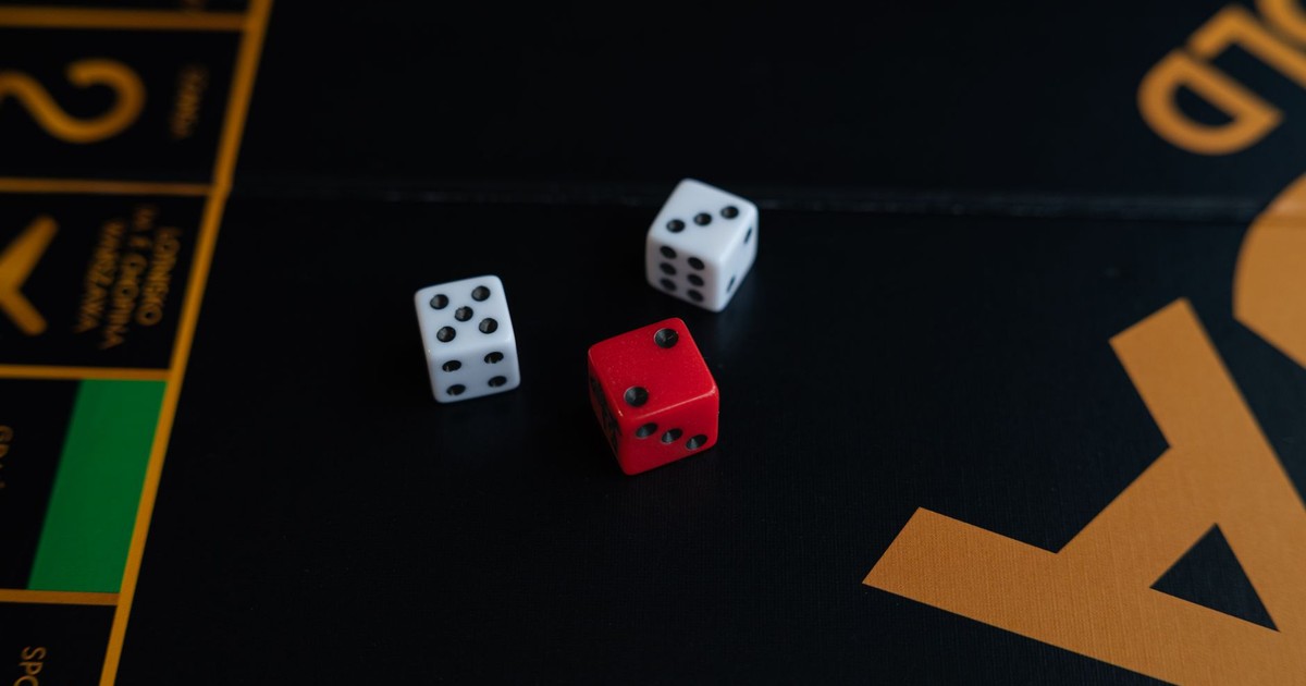 A close-up of red and white dice on a board game, evoking a sense of fun and strategy.