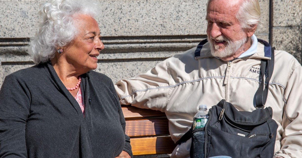 a man and a woman sitting on a bench