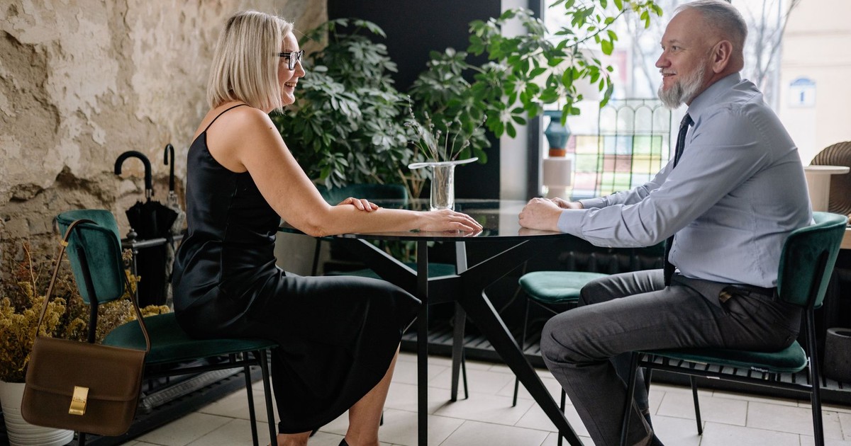 Sophisticated senior couple enjoying a romantic date in a stylish indoor setting.