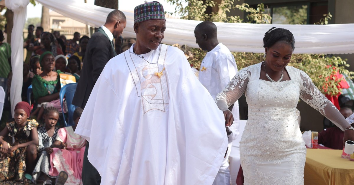 A vibrant outdoor African wedding ceremony with joyful bride and groom.