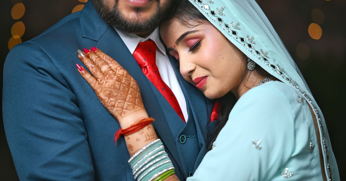 Close-up of a loving Indian couple embracing at their wedding in Shikohabad, UP, India.