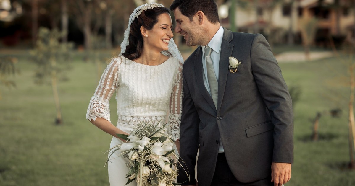 Happy couple enjoying a tender moment during their beautiful outdoor wedding ceremony.