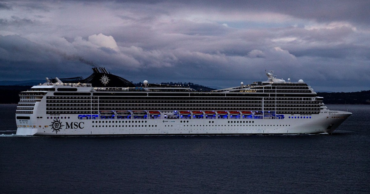 MSC cruise ship navigating waters near Hobart, Tasmania against a dramatic cloudy sky.
