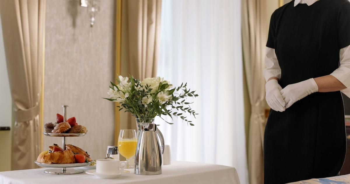 Elegant hotel room service setup with delicious breakfast and attentive service.